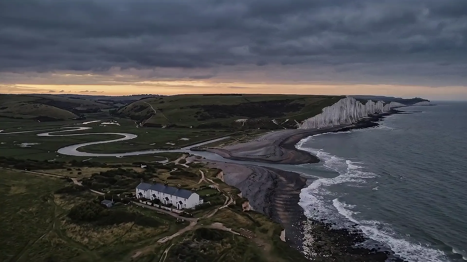 Flying east over Cuckmere Haven: the coastguard cottages, the river meandering down to the sea, and the Seven Sisters beyond